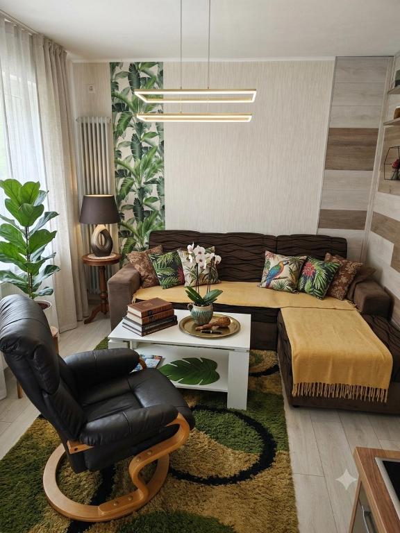 a living room with a couch and a chair at Teslić Apartman NiA in Teslić