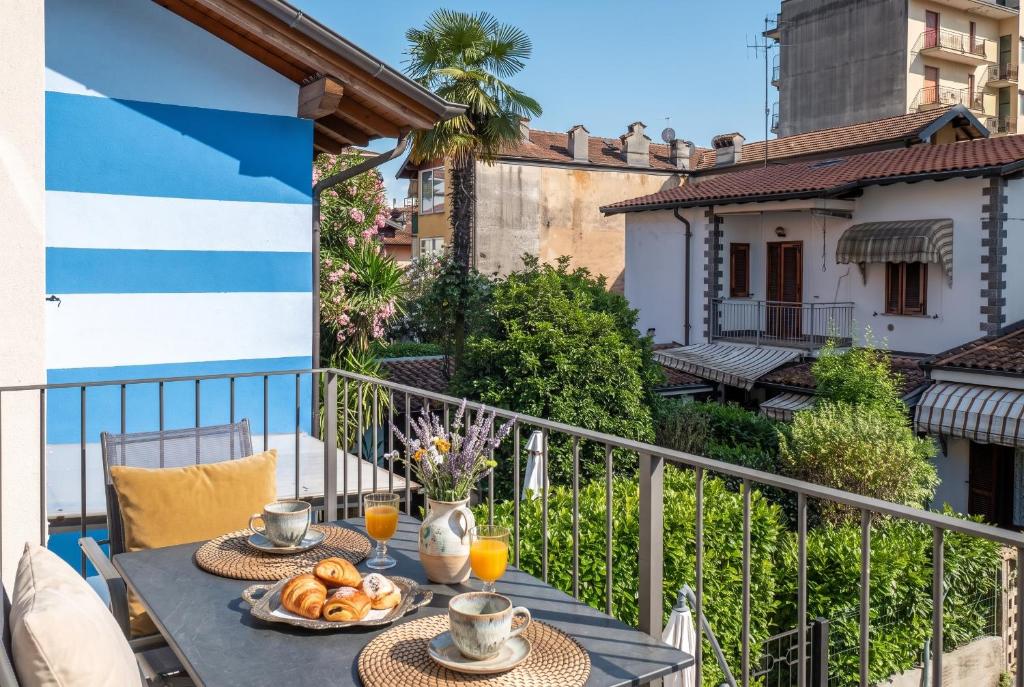 a table with food on top of a balcony at Casa Quadrifoglio - Ticino in Intra