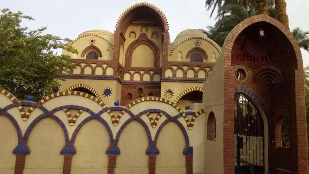 a building with a fence in front of it at Healing House in Luxor