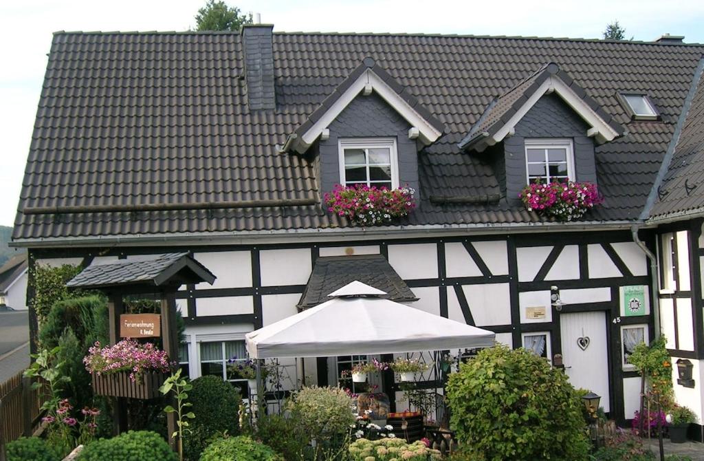 a black and white building with an umbrella at Gerkenhof in Olsberg