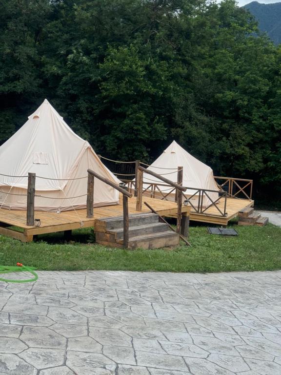 a couple of tents sitting in the grass at Vatra Bunătăților- By The Lake in Proeni