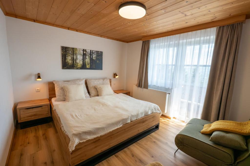 a bedroom with a large bed and a window at Ferienwohnung Tiefengraber in Weiz