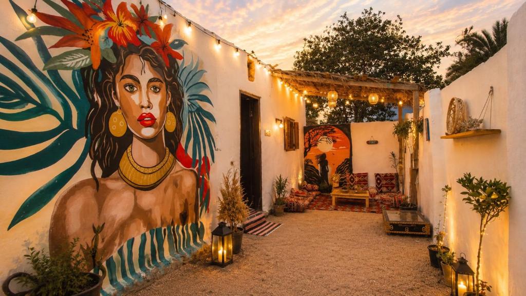 a hallway with a painting of a woman on a wall at Cozy Dahab Studio with Private Courtyard in Dahab