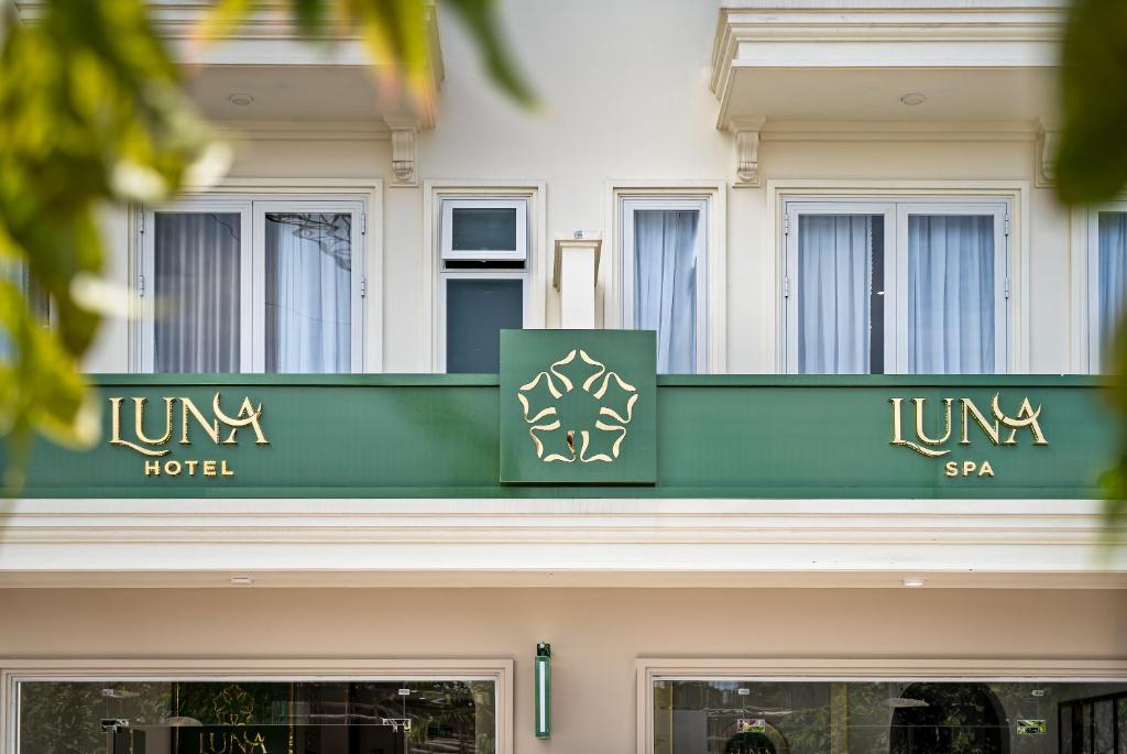 a hotel sign on top of a building at LUNA Hotel in Vĩnh Long