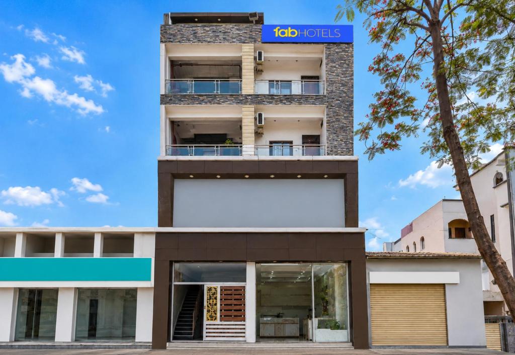 a building with a blue sign on top of it at FabHotel Metro Residency, Indore Junction Railway Station in Indore