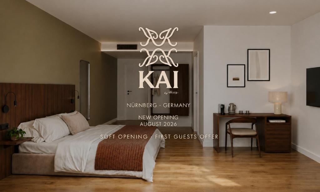 a bedroom with a bed and a table and a chandelier at The Haus KAI Nuremberg in Nuremberg