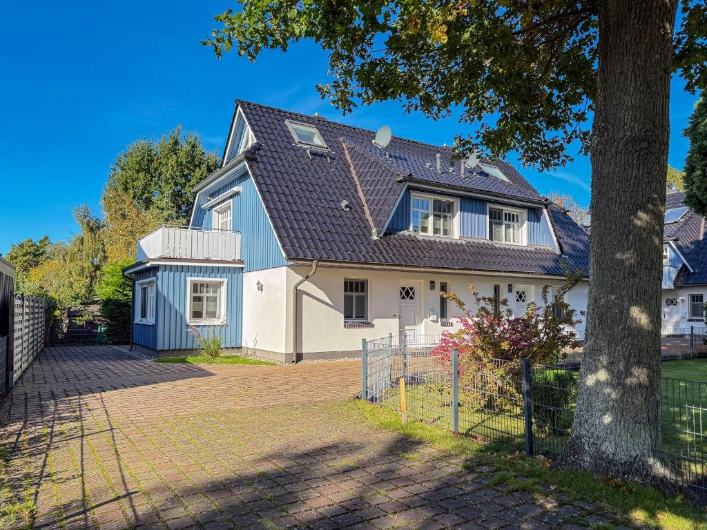 a white house with a gray roof at Kinnekulle 1 in Groß Kirr