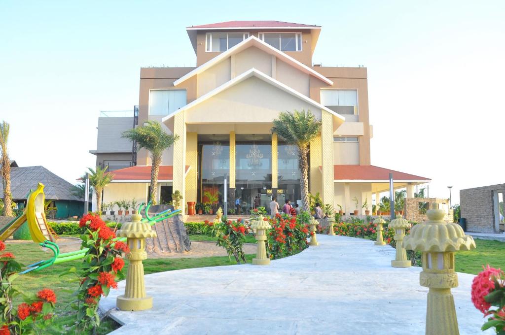 un edificio con flores delante en 7 Seasons resort & Spa, en Jamnagar