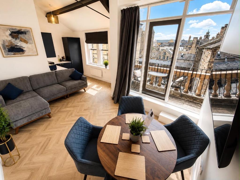 a living room with a table and a couch at Castle Chambers Serviced Apartments in Lancaster