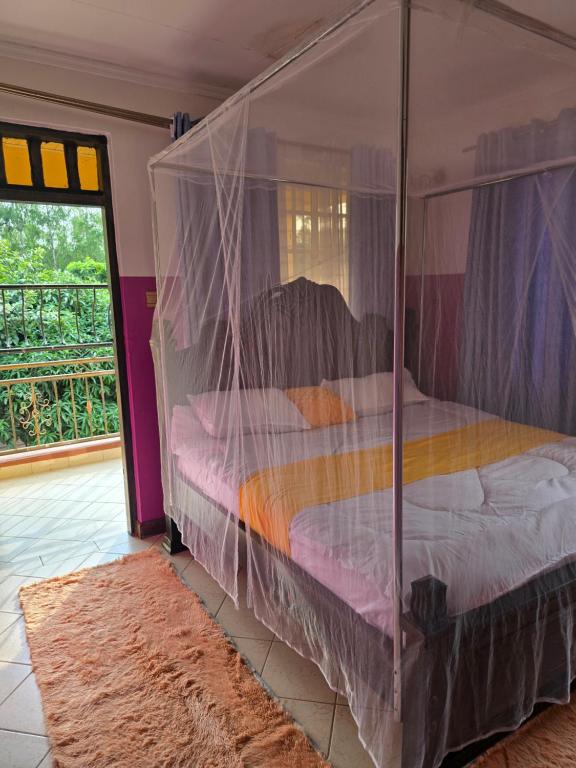 a bedroom with a bed covered in plastic at Rose Petals in Sagana