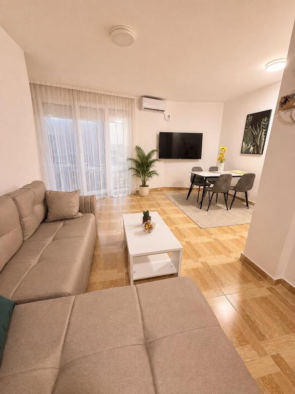 a living room with a couch and a table at Bo Apartment in Bečići