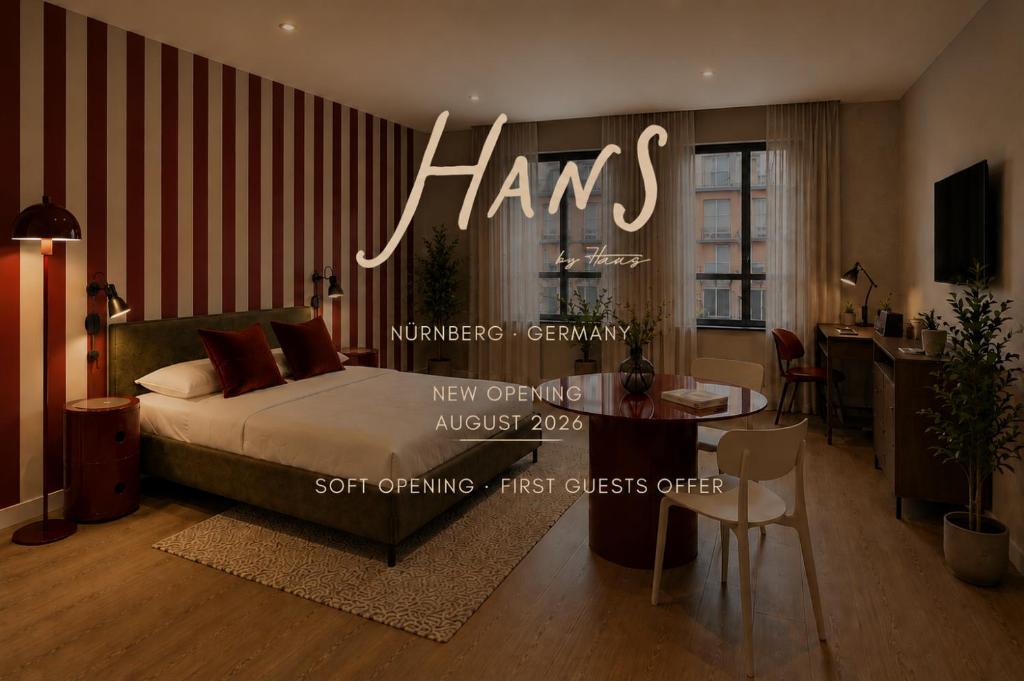 a hotel room with a bed and a dining room at The Haus HANS Nuremberg in Nuremberg