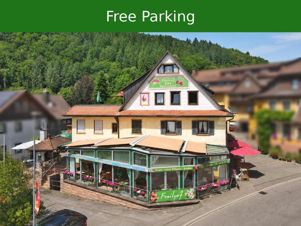 a building with a free parking sign on top of it at Hotel Restaurant Freihof in Oberharmersbach