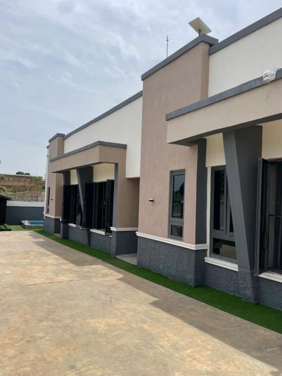 a large building with a sidewalk in front of it at Sandton Luxury Apartment in Bardon Yana