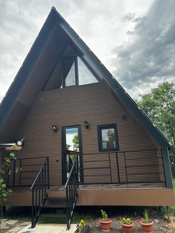 a house with a large window on the side of it at kesis chalet in Borjomi