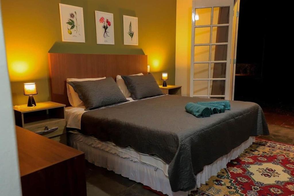 a bedroom with a large bed in a room at Private Suite with Kitchen & Pool Access in Itapetininga