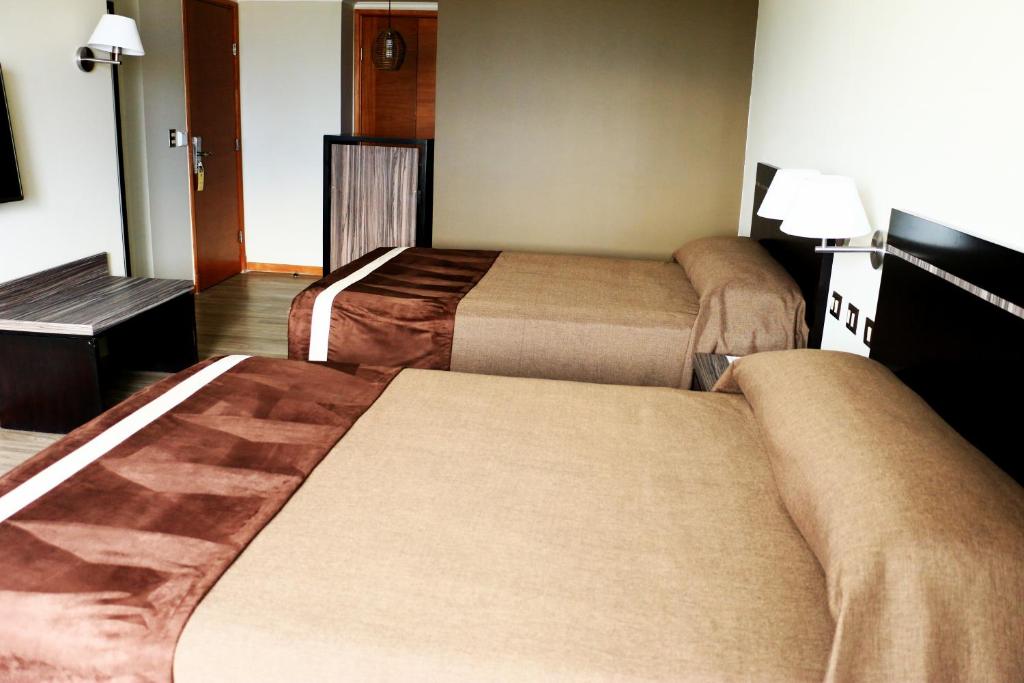 Postel nebo postele na pokoji v ubytování Hotel Diego de Almagro Providencia