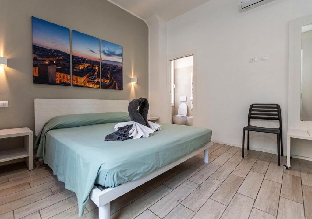 a bedroom with a bed and a chair at Moon Bologna in Bologna