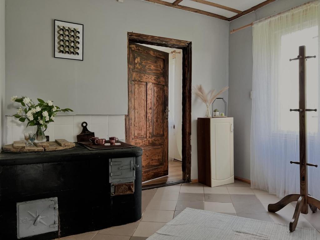a room with a wooden door and a refrigerator at Viesu nams Kātiņi in Energetikis