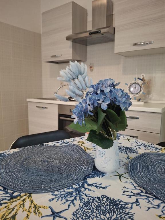 a vase with blue flowers sitting on top of a table at Costa Marina in Marsala