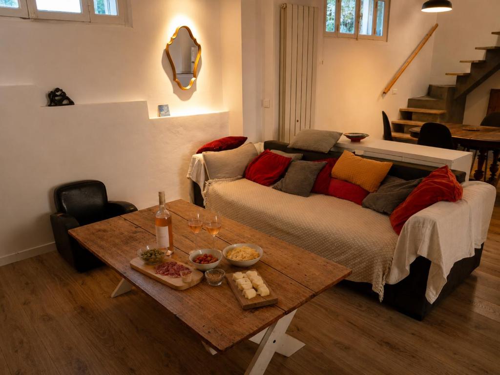 a living room with a couch and a table at Authentique maison de village à Agde avec patio in Agde