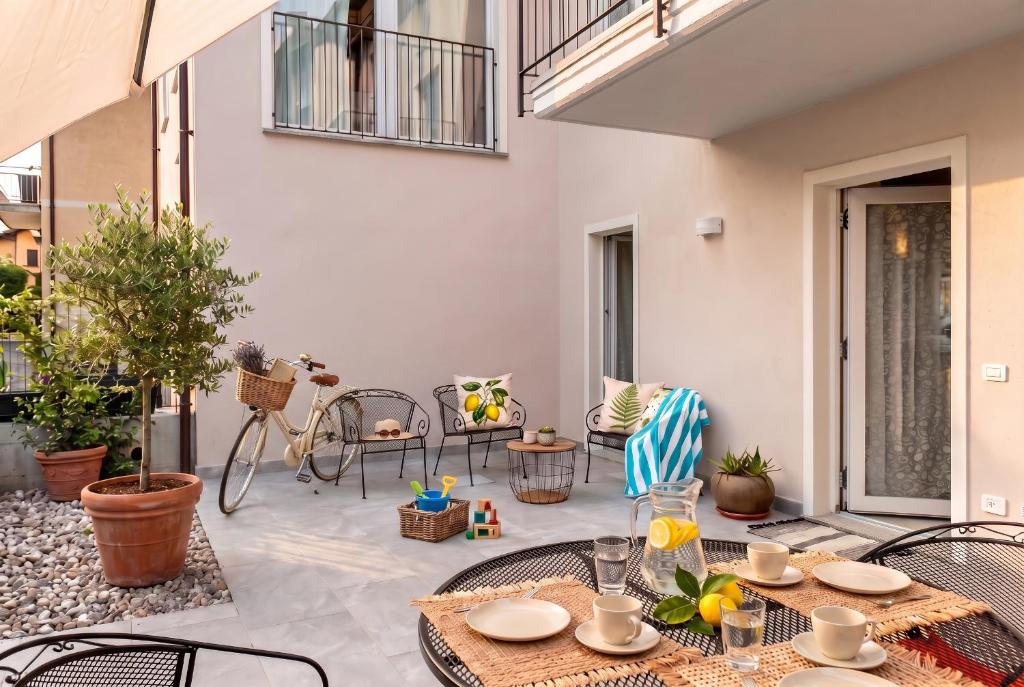 an outdoor patio with a table and chairs at Casa Quadrifoglio - Valgrande in Intra