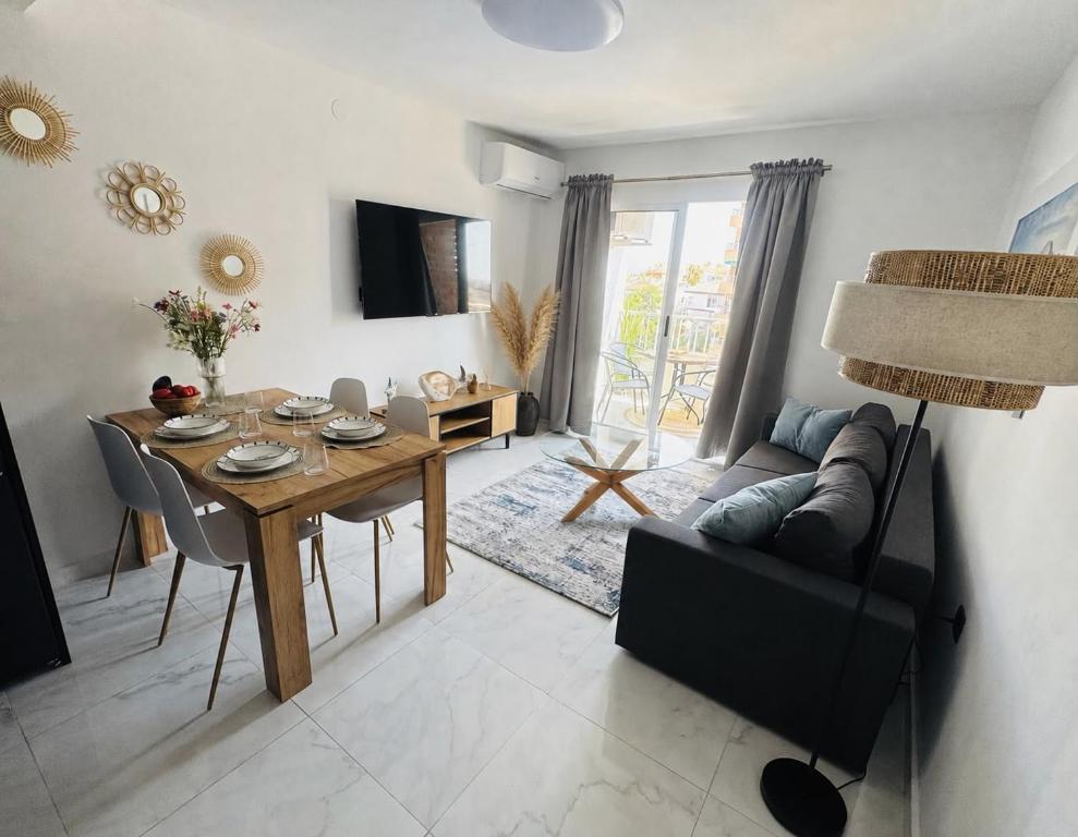 a living room with a table and a couch at Punta Prima Sun & Sea Apartament in Punta Prima