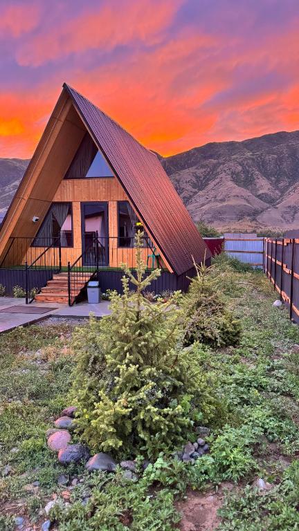 a house with a roof on top of a hill at Kolsay A-Frame Yessen in Saty