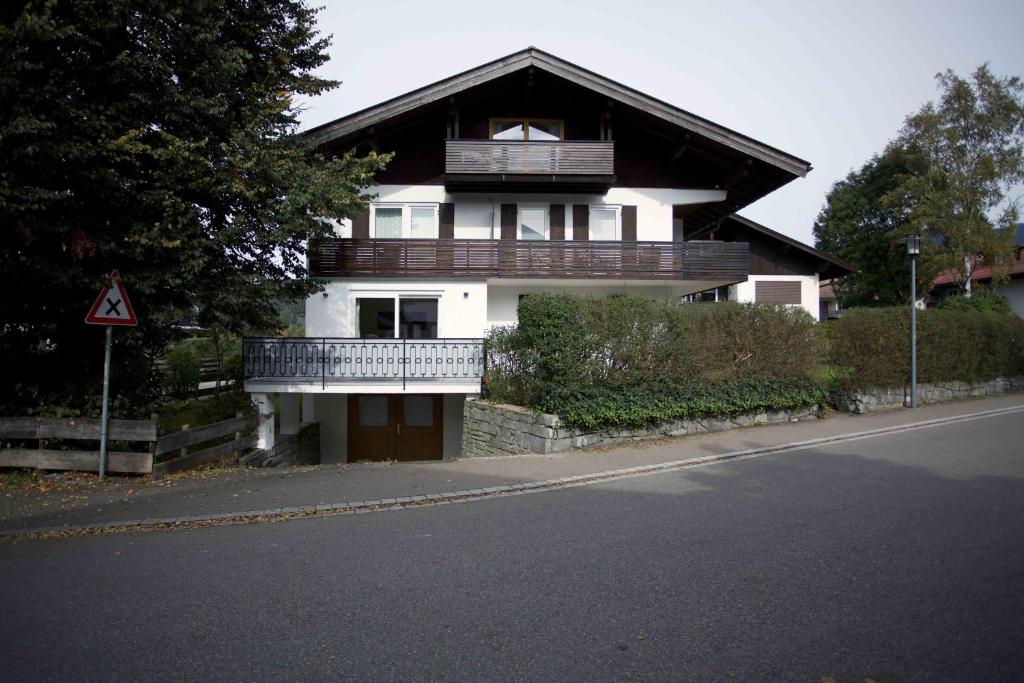 a house with a balcony on the side of a street at Landhaus Ela in Oberstdorf