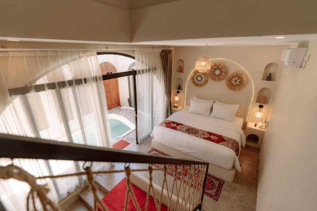 a hotel room with a bed and a staircase at Maroko Jogja Villas With Privatepool in Ngaglik