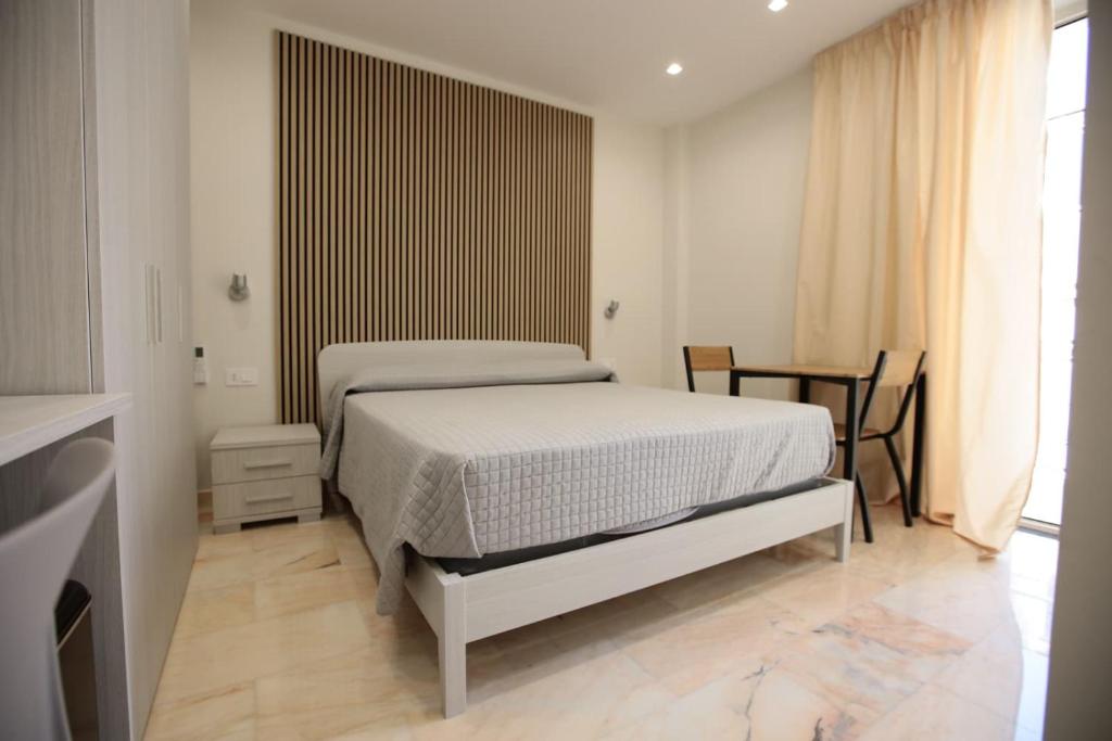 a bedroom with a white bed in a room at Dimora del mare in Agropoli