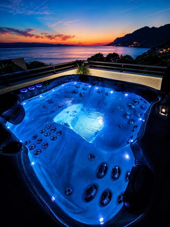 a jacuzzi tub with a view of the ocean at Apartman Štorija with Private Jacuzzi-Brela in Brela