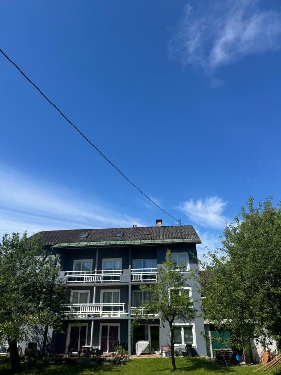 an apartment building with a blue sky in the background at Guesthouse Mother in Sielach