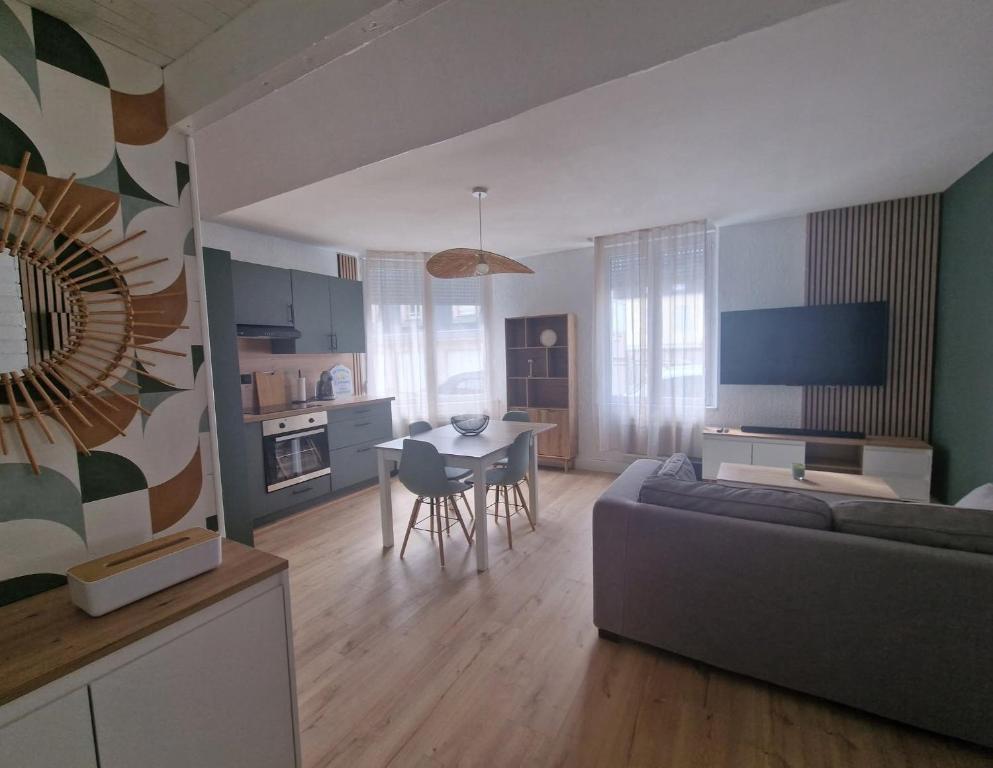 a living room with a couch and a table at Casa Bahia in Berck-sur-Mer