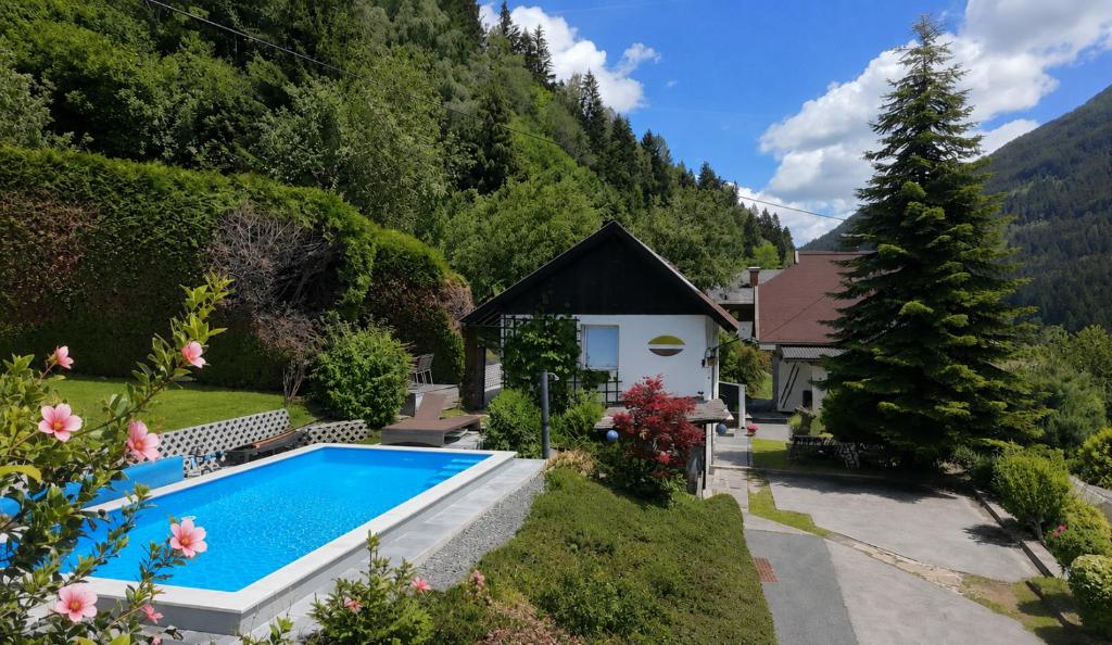 a house with a swimming pool in a garden at Haus St Peter , midden in meren gebied van Karinthië in Radenthein