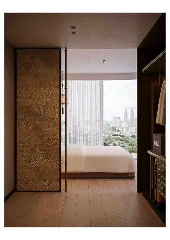a bedroom with a bed and a sliding door at DUHORÉA Hotel and Wellness in Hanoi