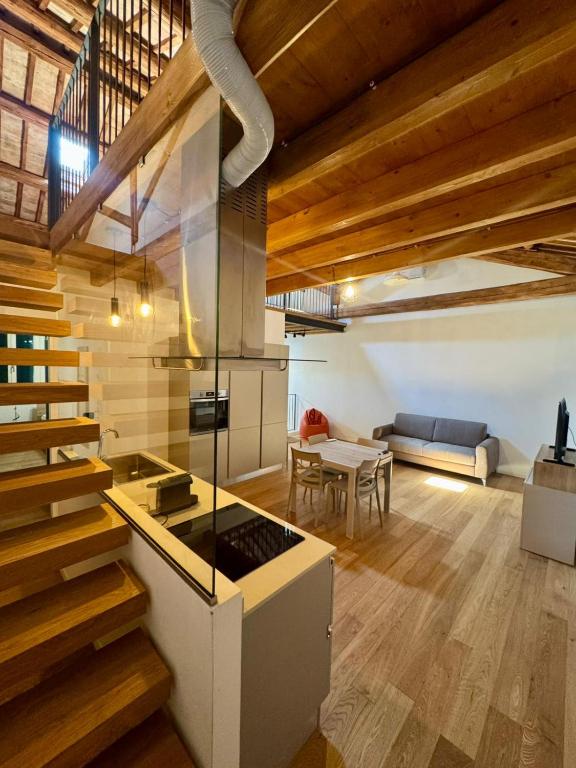 a kitchen with a stove and a living room at ERMAN HOUSE - Dimora del Doge in Dolo