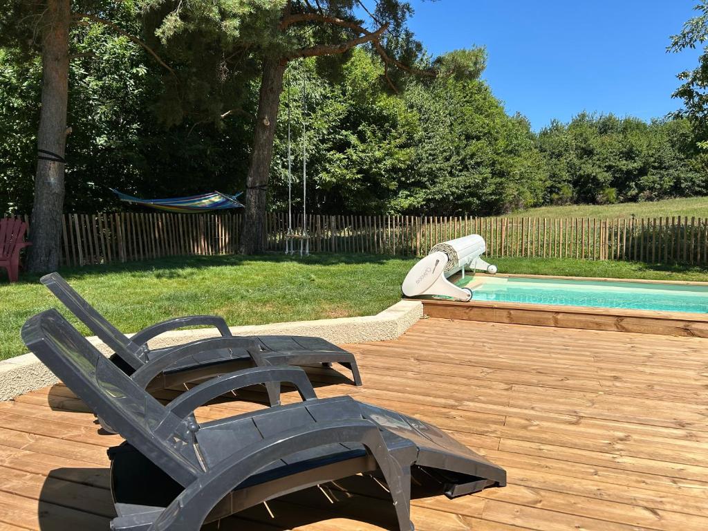 a patio with a chair and a swimming pool at Gîte Alice Piscine privée in Hauterives