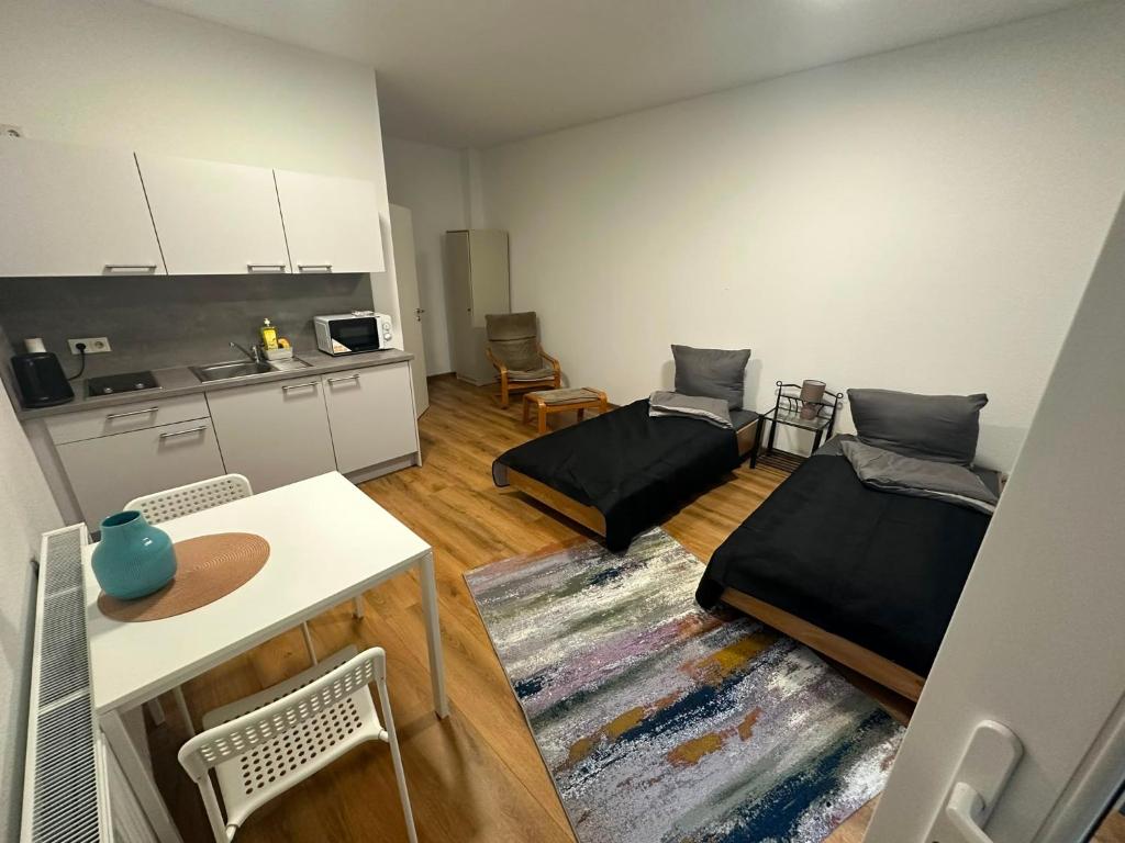 a small room with two beds and a kitchen at Sky Appartment in Koblenz