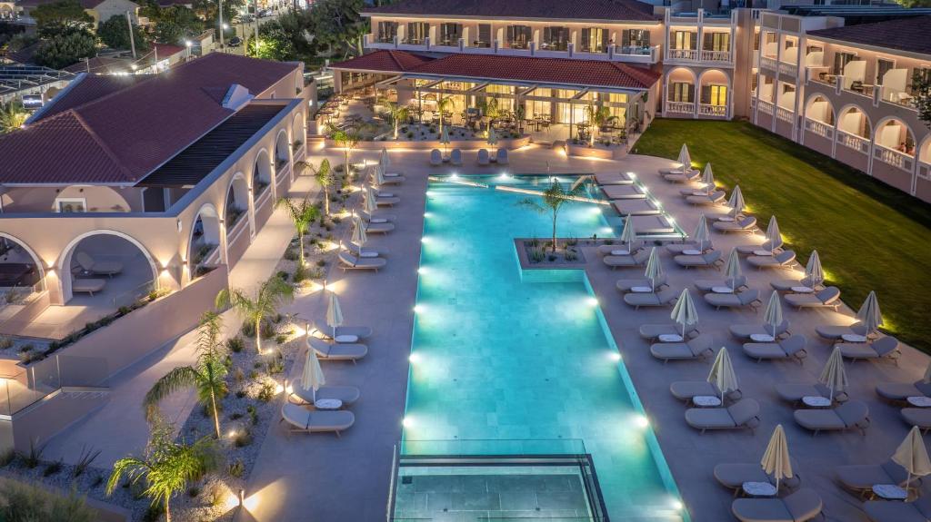 an aerial view of a resort with a pool and lounge chairs at Hotel Palmyra in Argassi