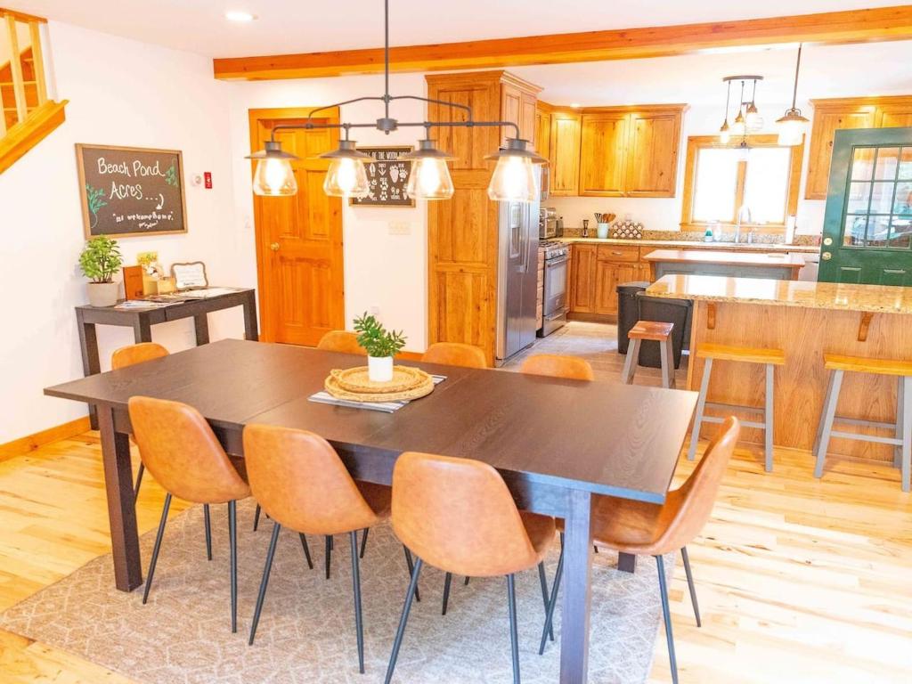 a kitchen with a dining room table and chairs at Peaceful Winnipesaukee Retreat, Walking Trails in Wolfeboro