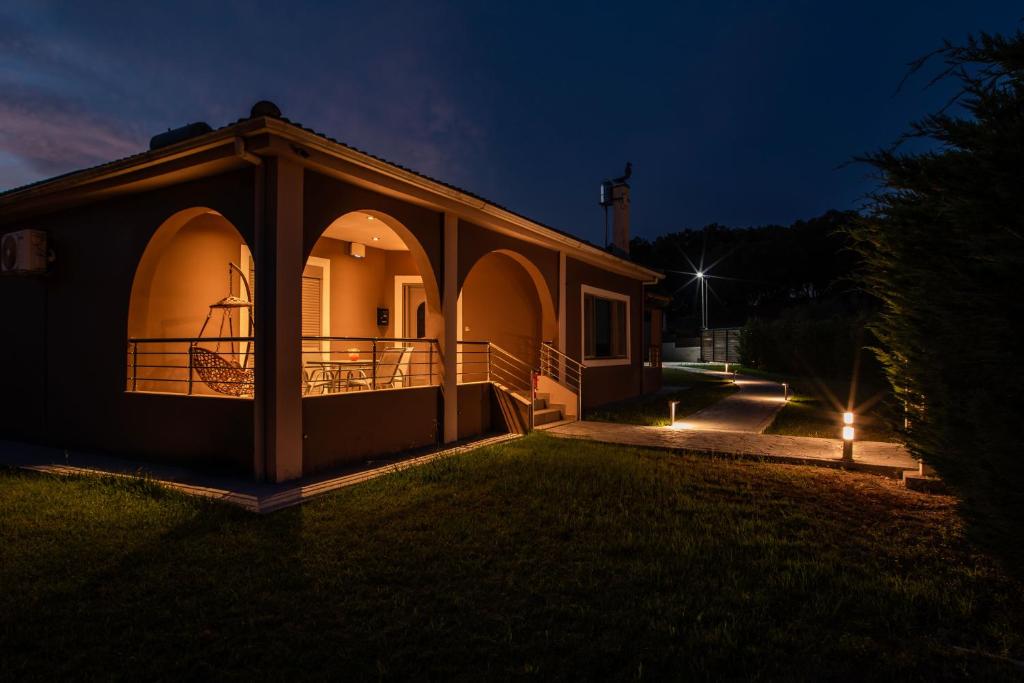 a small house with a gazebo at night at Villa giannis in Vitalades