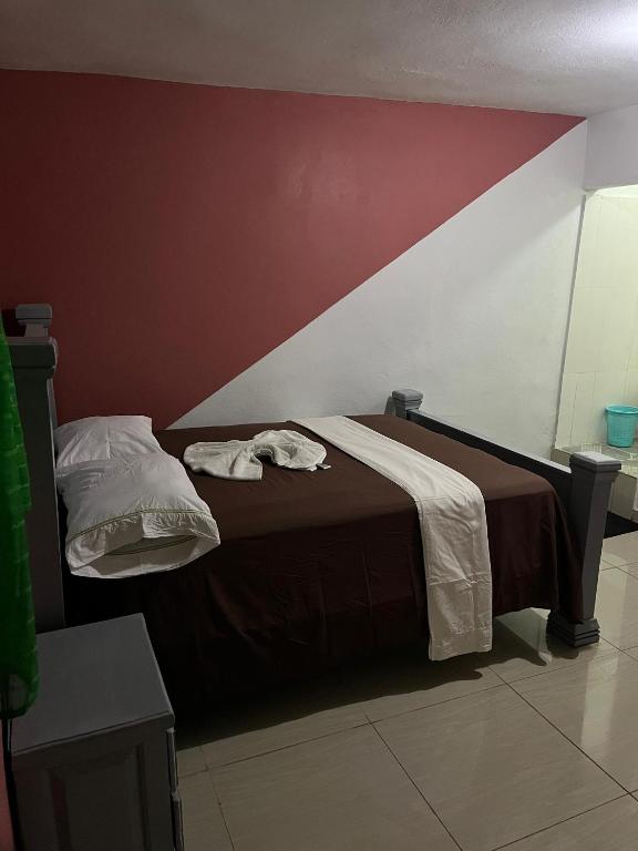 a bed with two towels on it in a room at BAYO-HOTEl in Cap-Haïtien