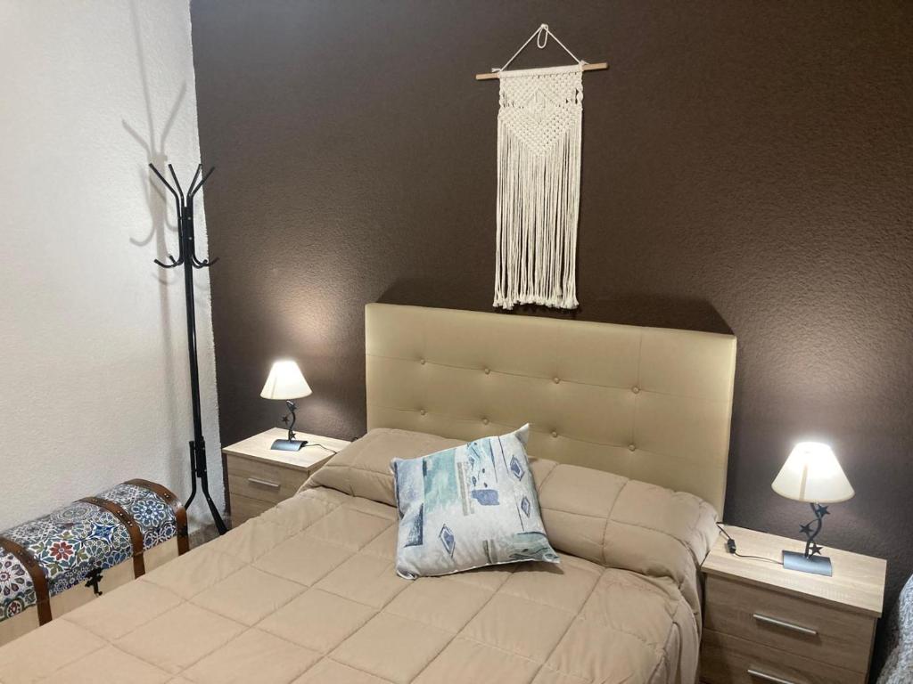 a bedroom with a bed with two night stands and two lamps at Habitación privada con zonas compartidas in Castellbisbal
