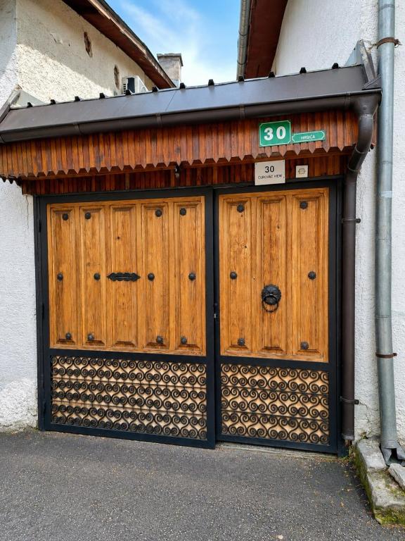 a pair of wooden doors on the side of a building at Curovac View in Sarajevo