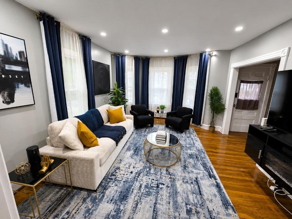 a living room with a couch and a table at Sleeps 6 Near Boston, Providence & Gillette in Attleboro