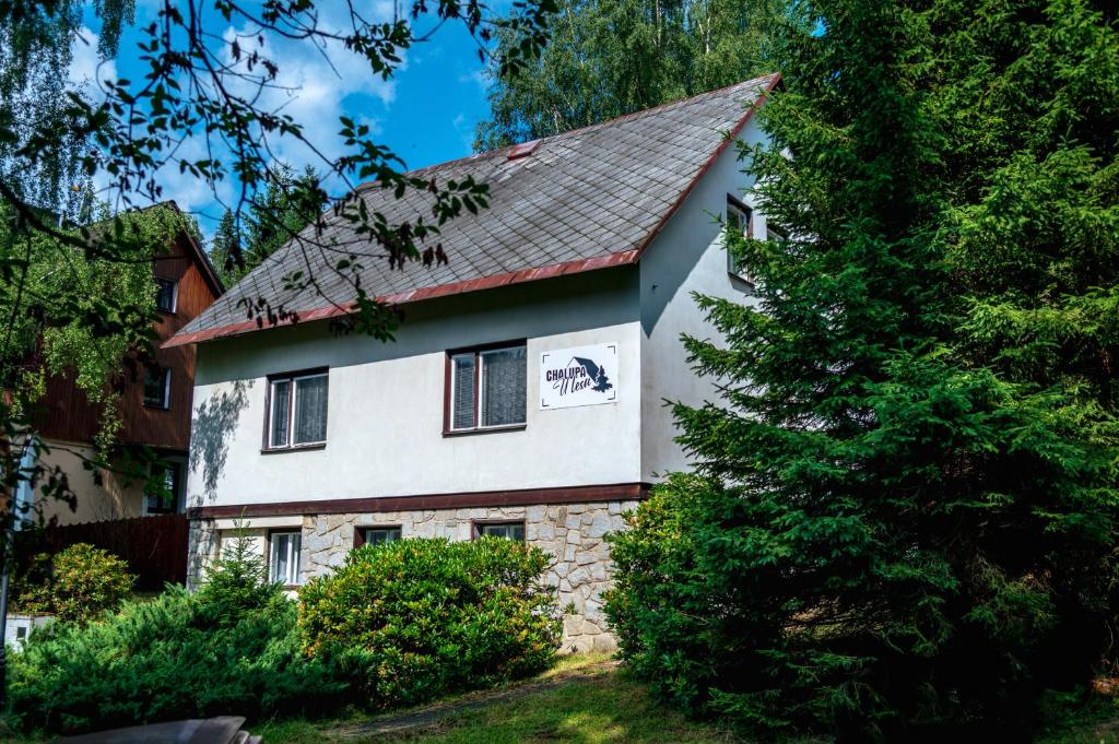a white house with a red roof at Chalupa U lesa in Karlova Studánka