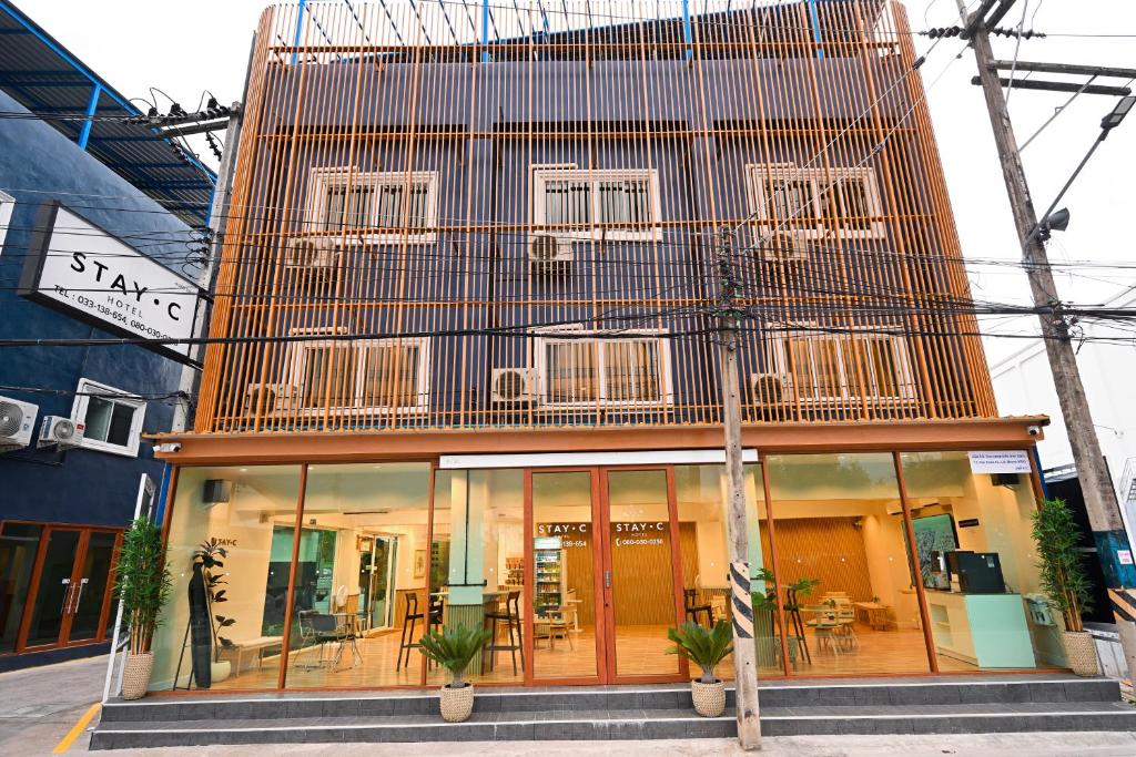 a building with a balcony on top of it at Stay C Hotel in Ban Samet