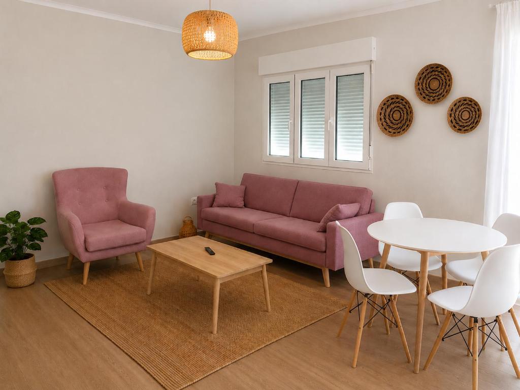a living room with a couch and a table and chairs at Casa Candola in Noya