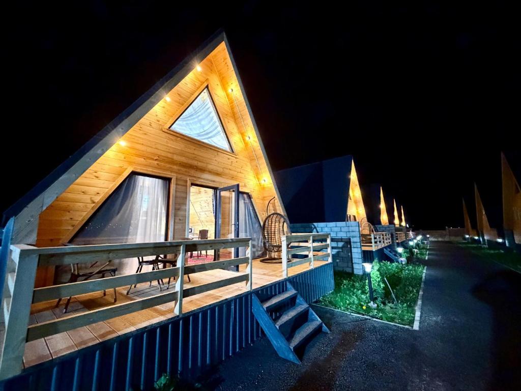 a cabin with a lit up roof at night at A-Frame in Dolinka